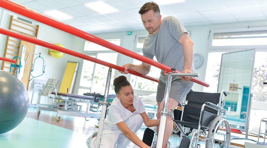 Nurse assisting Patient in Physical Therapy Excercise