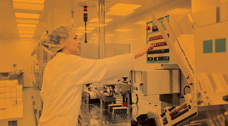 Cleanroom and Containment Amber Lighting featuring lab worker in photosensitive laboratory